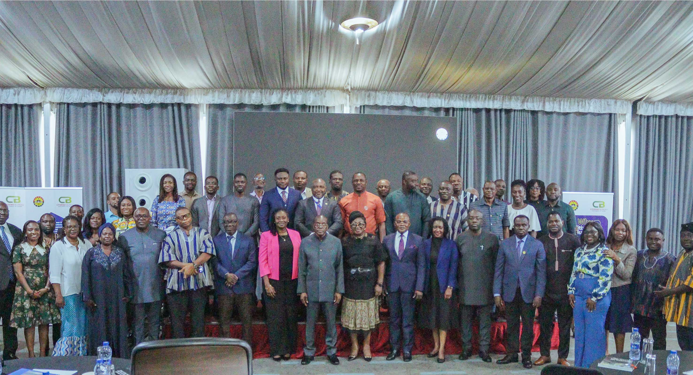 Participants from Parliament, Civil Service, academia and civil society organisations join a group photograph.
