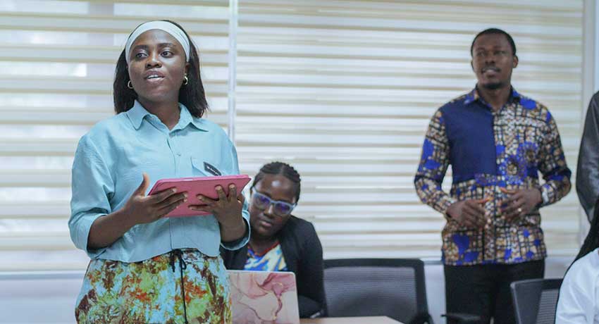 A student presents her group’s findings during the final presentations, demonstrating the practical application of lessons from the Research School.